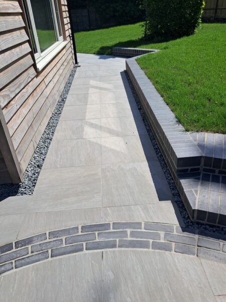 Porcelain paving, brick retainer and new lawn